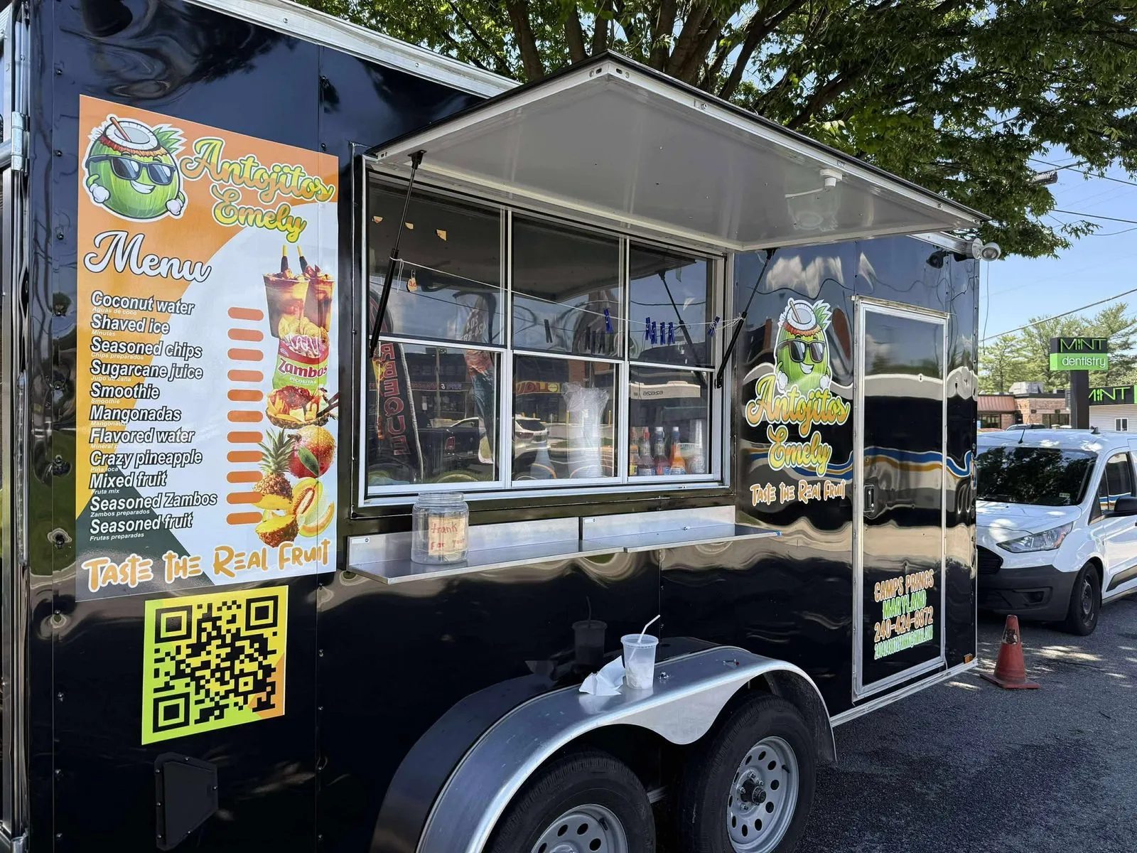 Antojitos Emely food trailer, side view with menu board wrap