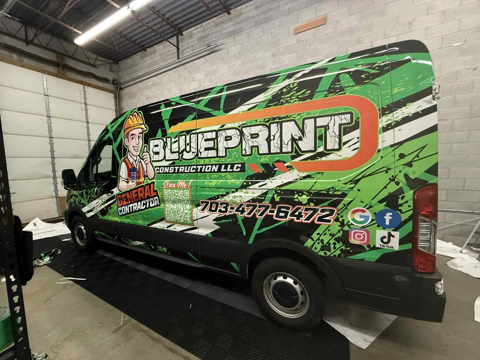 Blueprint Construction LLC van with green contractor-themed wrap