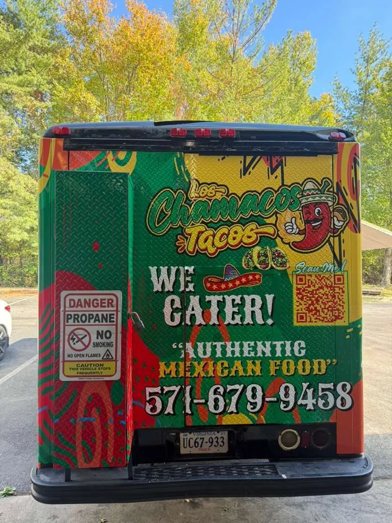 Los Chamacos Tacos food truck, front three-quarter view, colorful wrap