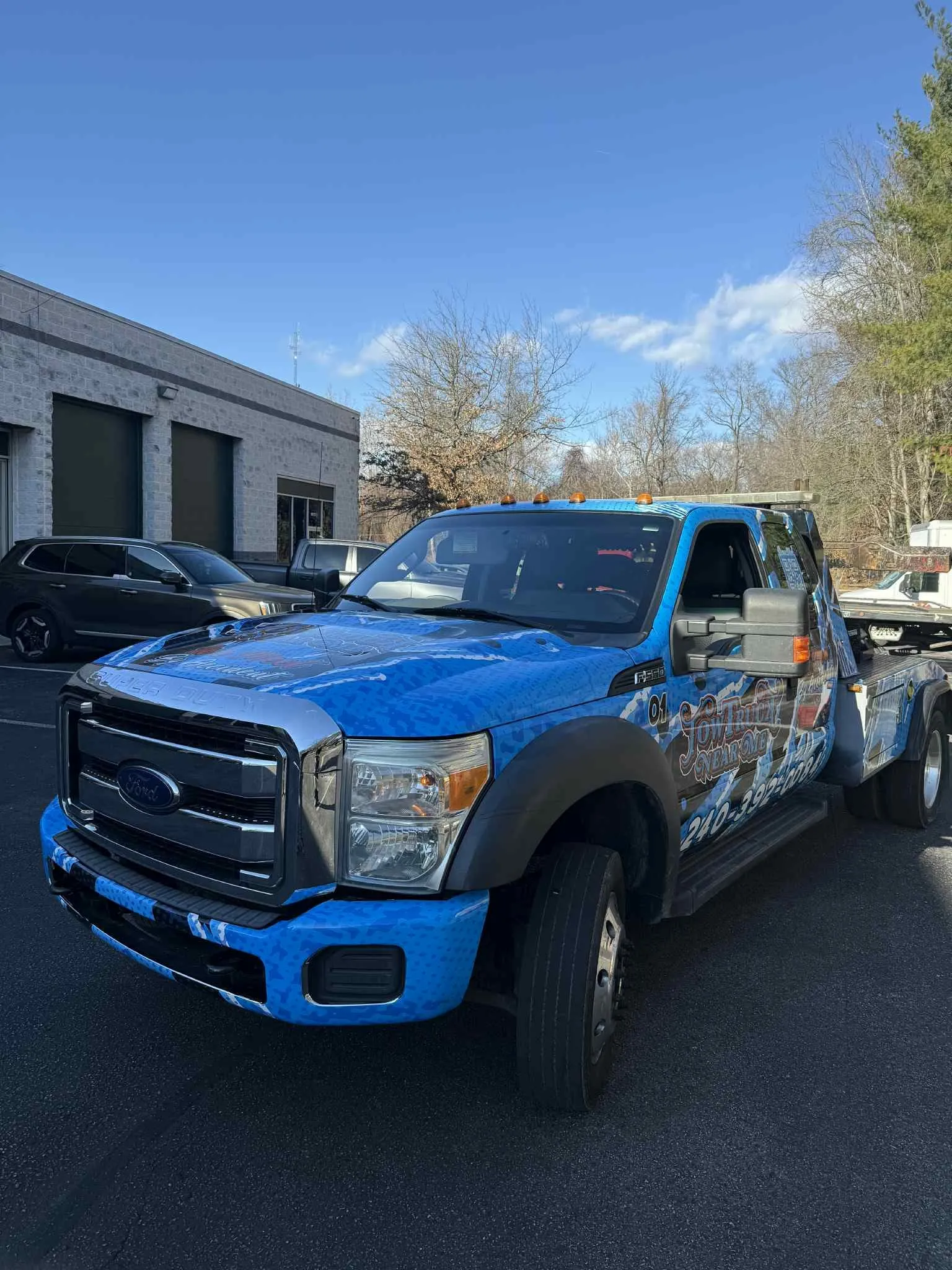 Dually pickup truck with light blue wolf-themed graphics wrap