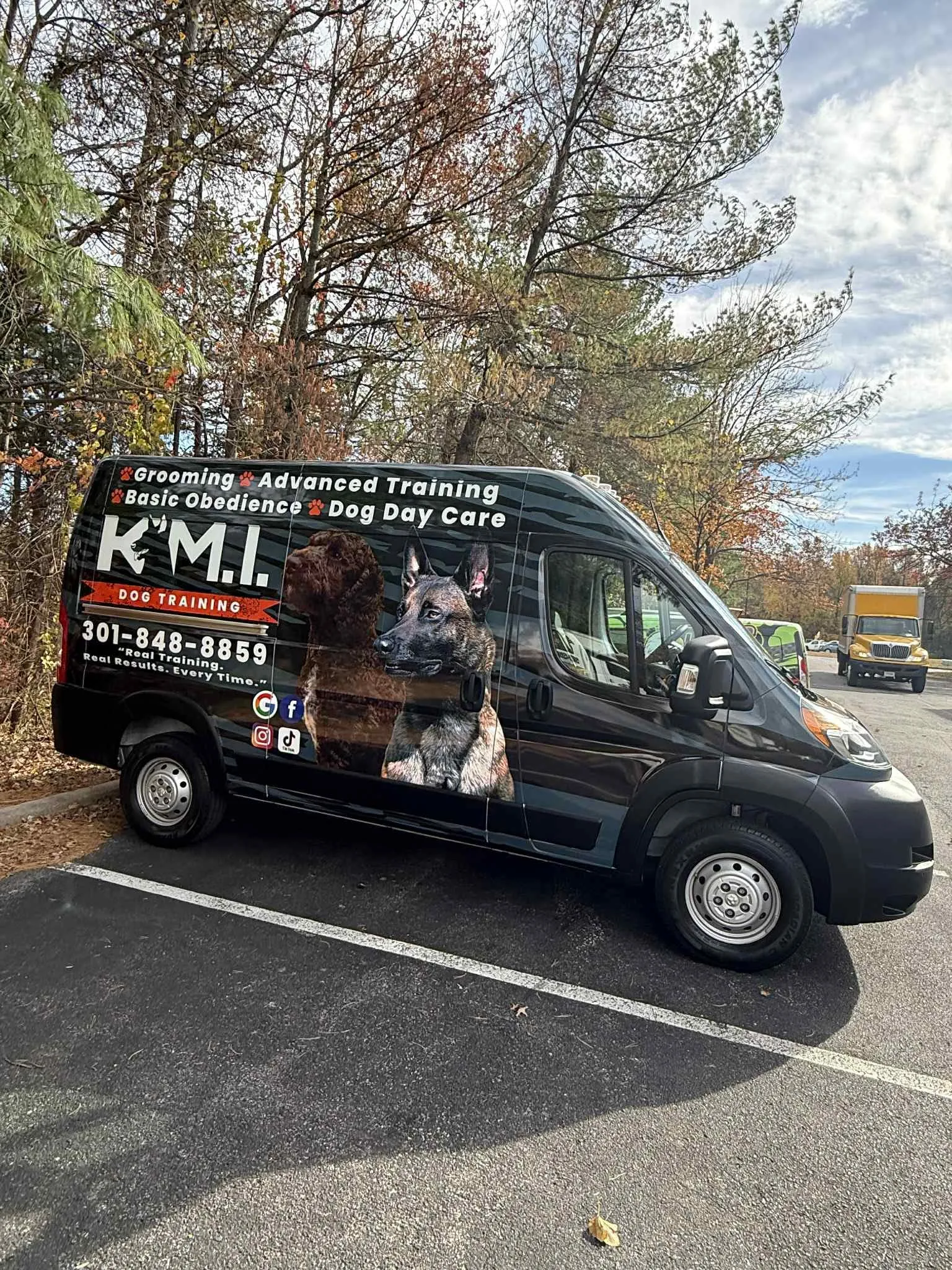 K.M.I Dog Training and Grooming van with dog photos wrap
