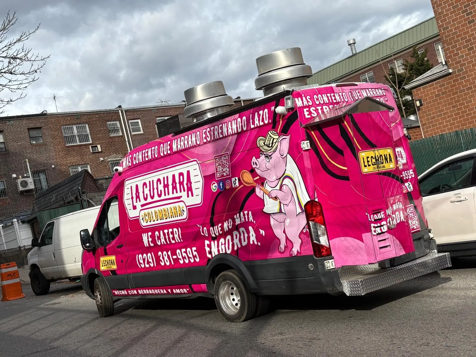 La Cuchara Colombiana food truck, rear view, pink wrap with pig mascot