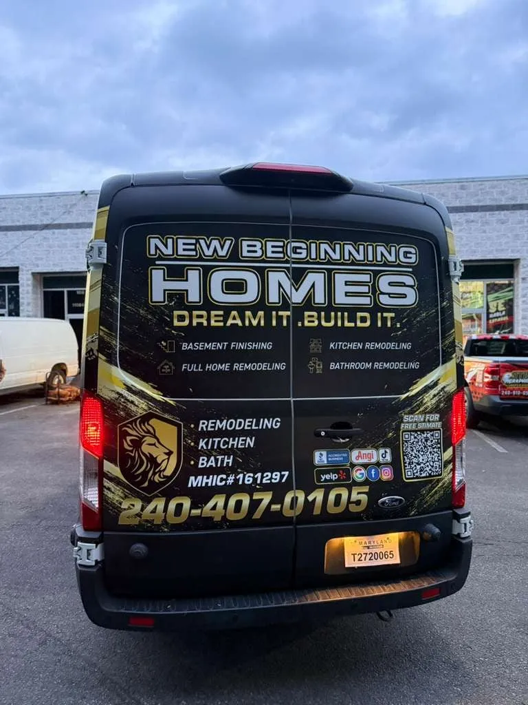 New Beginning Homes van, rear view, black and gold wrap