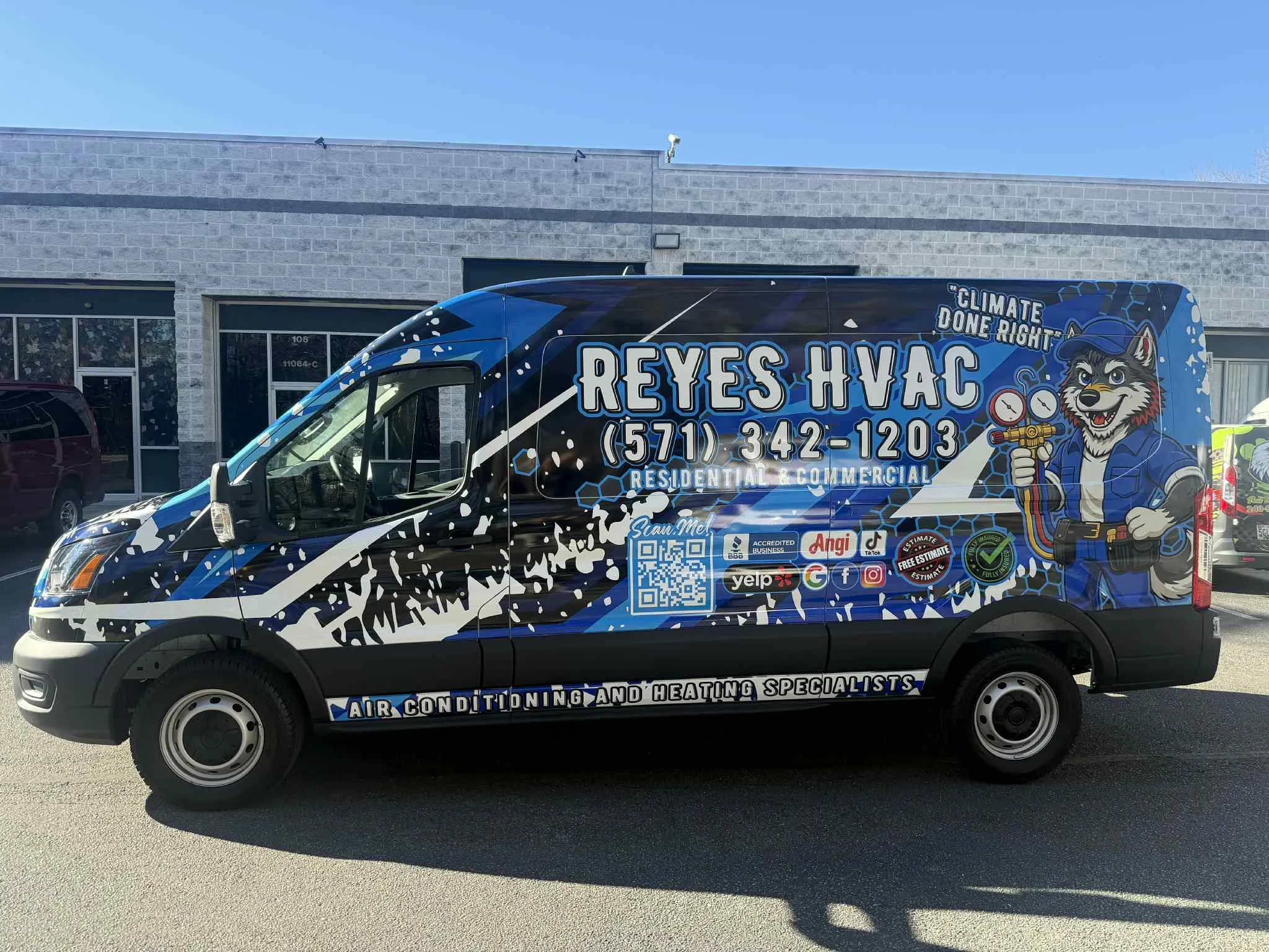 Blue full vehicle wrap on an HVAC service van with custom mascot artwork