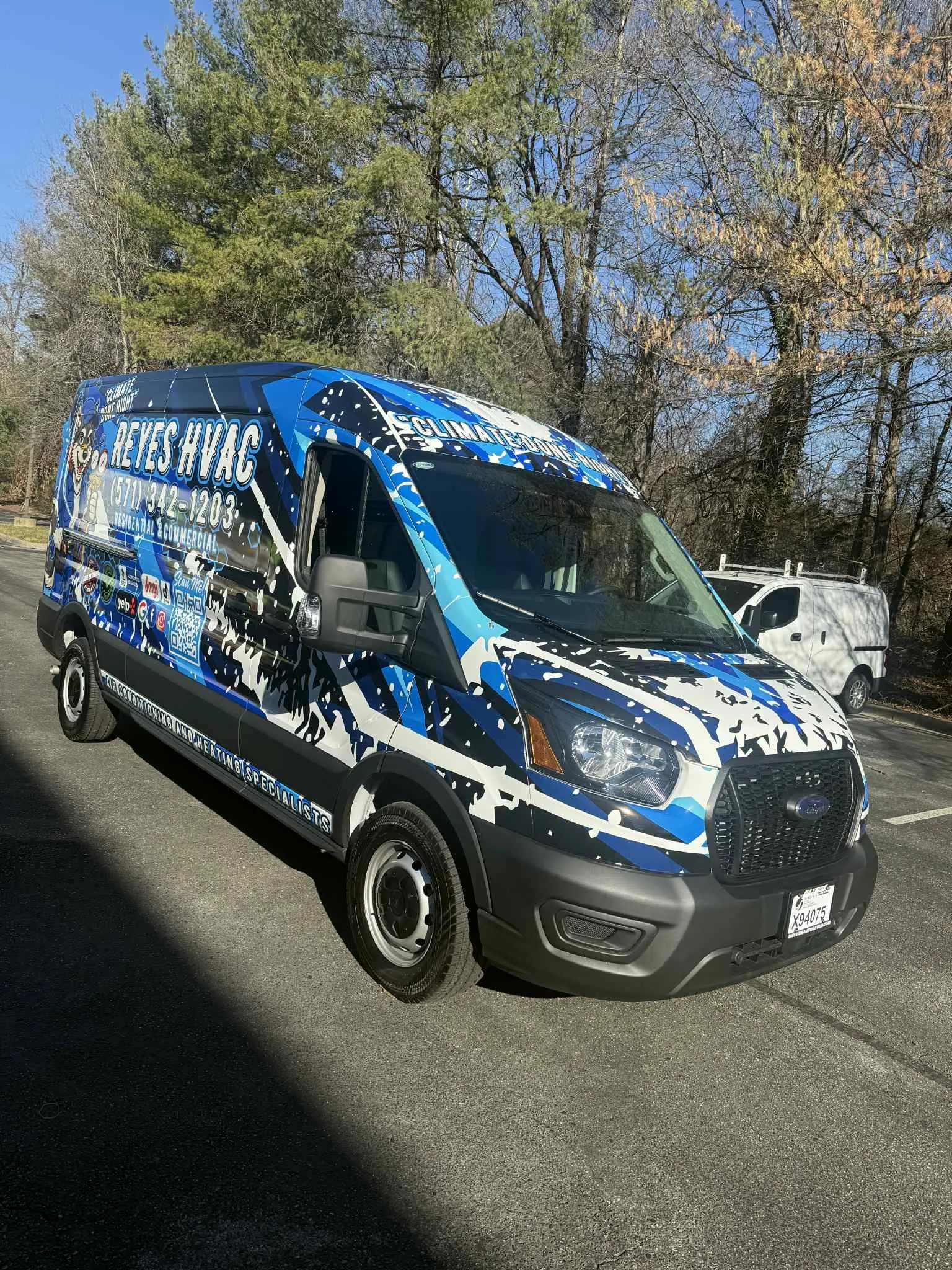 Reyes HVAC van with white and blue paint-splash wrap